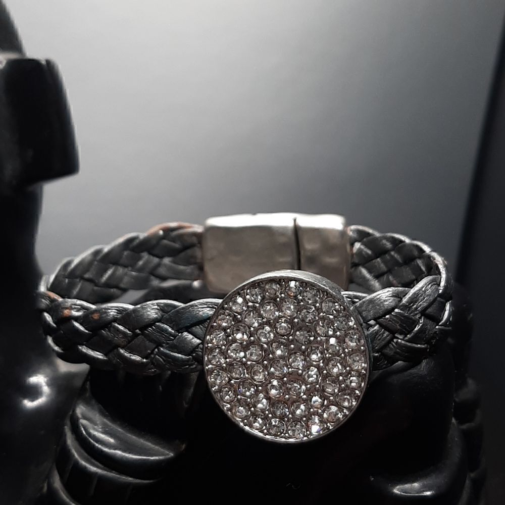 Vintage bracelet with silver band and circle with rhinestones in the center